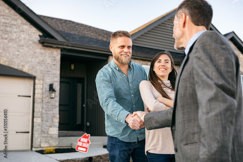 Real Estate Agent Shakes Hands With Client photo
