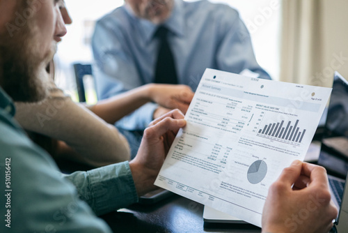 Man Looks At Investment Historical Performance Chart photo