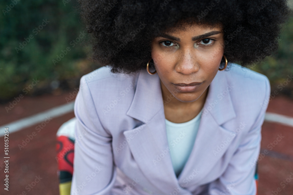 Generation Z model with afro hair style in outdoor studio
