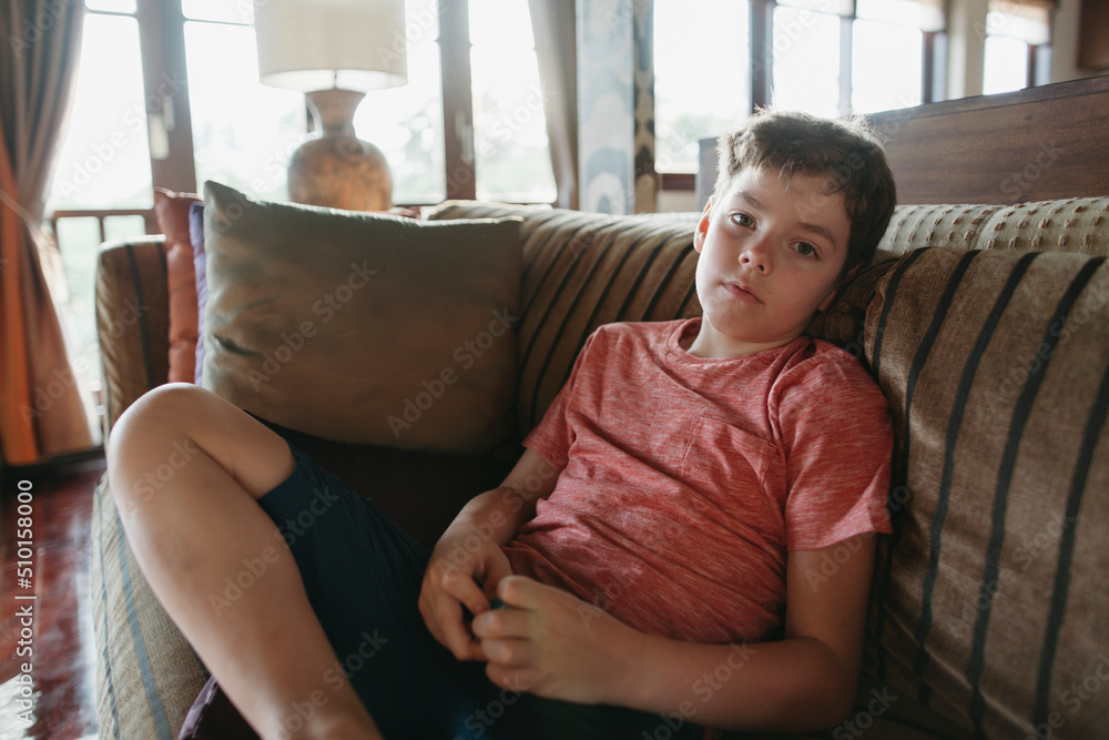 Young boy resting at home. Young boy resting at home.