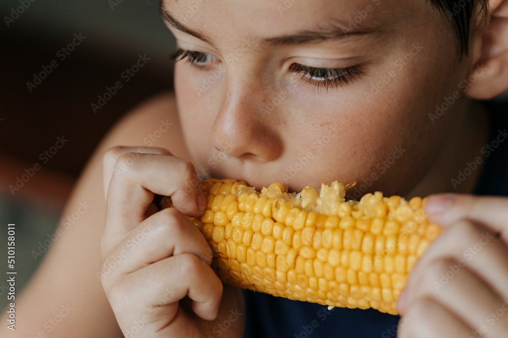 Kid eating corn. Kid eating corn.