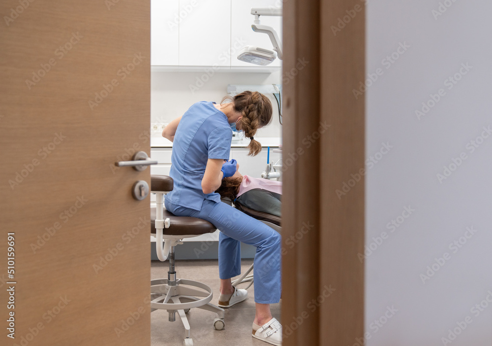 Dentist Performing Treatment To Patient Dentist Performing Treatment To Patient