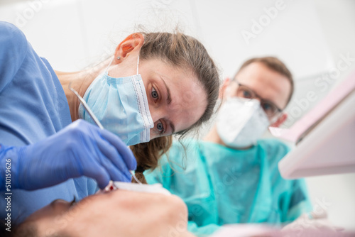 Close Up Of Two Dentists Performing Treatment  photo