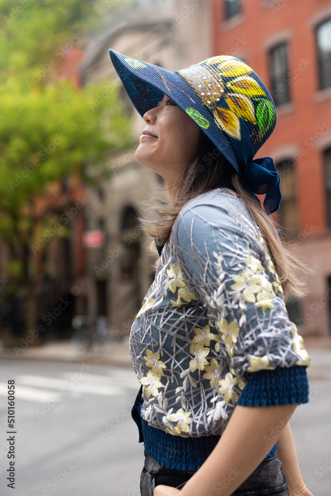 © Lauren Lee/Stocksy - Smiling woman in neighborhood