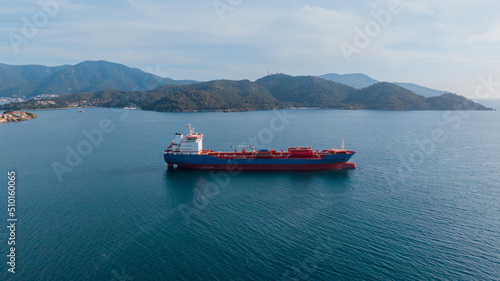 aerial view of an oil tanker moving along the coast photo