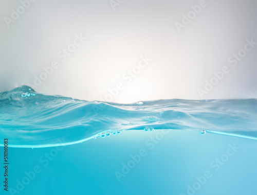 Blurred beautiful swaying water waves splashing water waves in clean blue water.