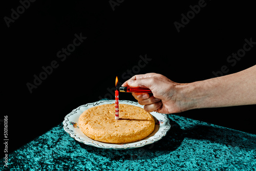 lighting a candle on a spanish omelette photo