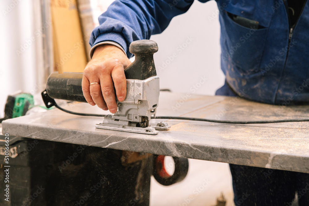 anonymous handyman cutting countertop with jigsaw