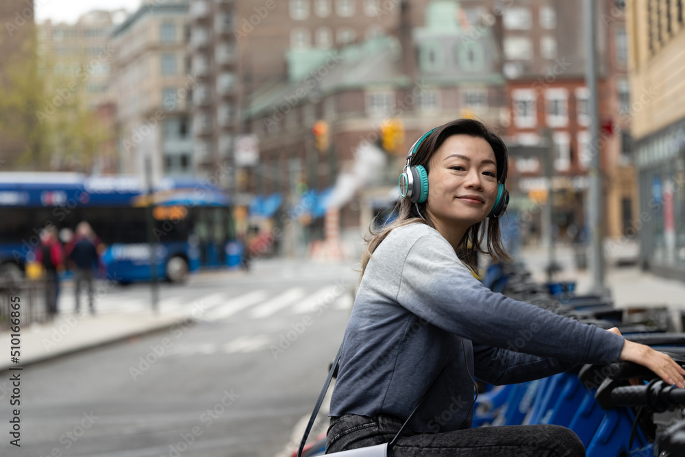 © Lauren Lee/Stocksy - Woman smiling on bike