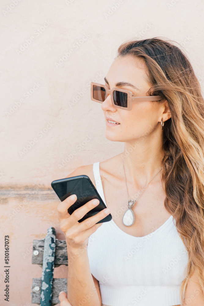 Woman holds Her Phone Standing On The Street. Woman holds Her Phone Standing On The Street.