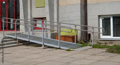 A  metal ramp and stairs for wheelchairs  in a  school for disabled  children photo