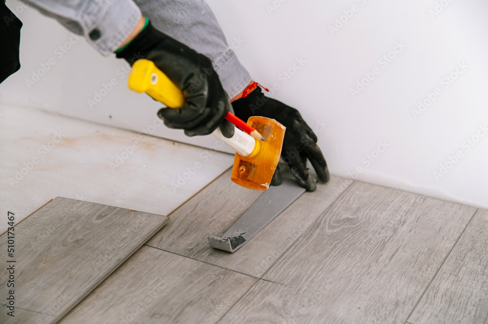 anonymous Interior designer assembling floor planks anonymous Interior designer assembling floor planks