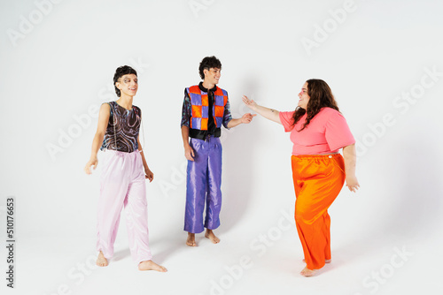 Three best friends posing in studio, wearing summer style outfit photo