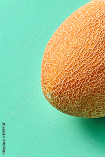 Natural ripe melon on a biscay green background. photo