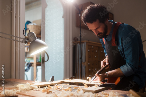 Young craftsman working at his workshop  photo