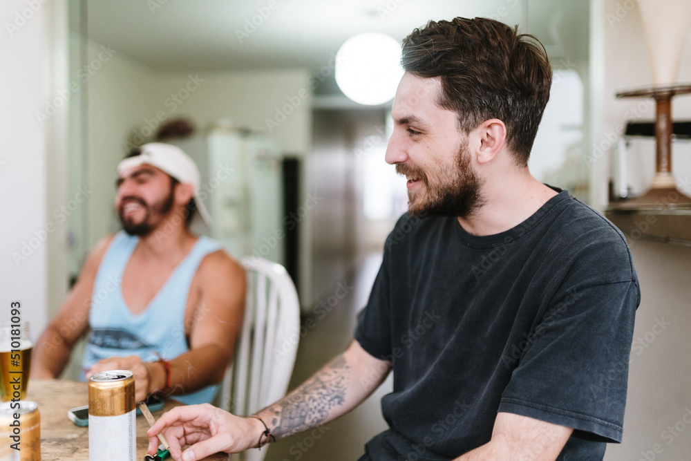 Man smoking weed and laughing with friends Man smoking weed and laughing with friends