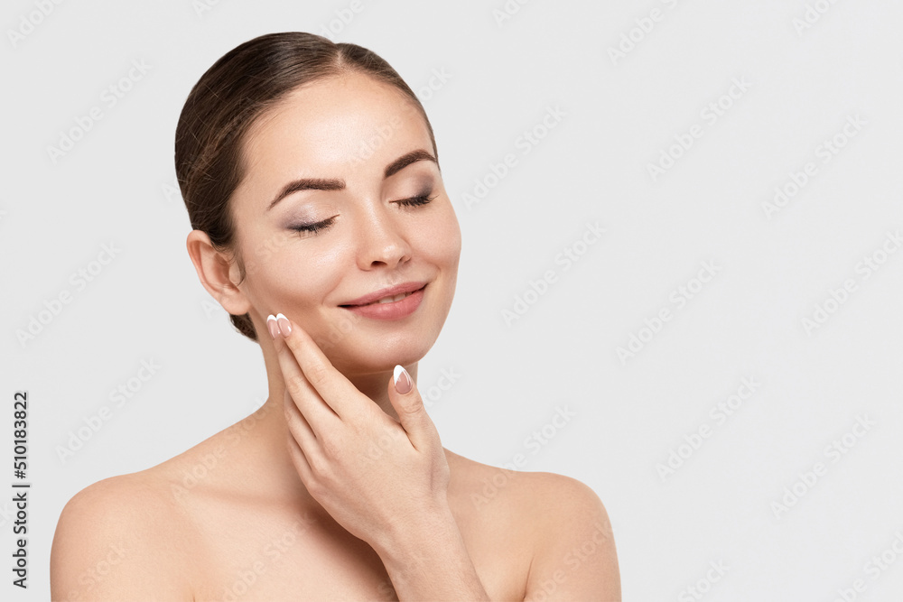 Beautiful Young Woman with Clean Fresh Skin touch own face. Facial treatment. Cosmetology, beauty and spa Beautiful Young Woman with Clean Fresh Skin touch own face. Facial treatment. Cosmetology, beauty and spa