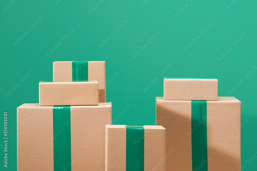 Cardboard boxes on green background Cardboard boxes on green background