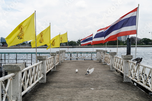 Thai flags flying on a pier in Bangkok photo
