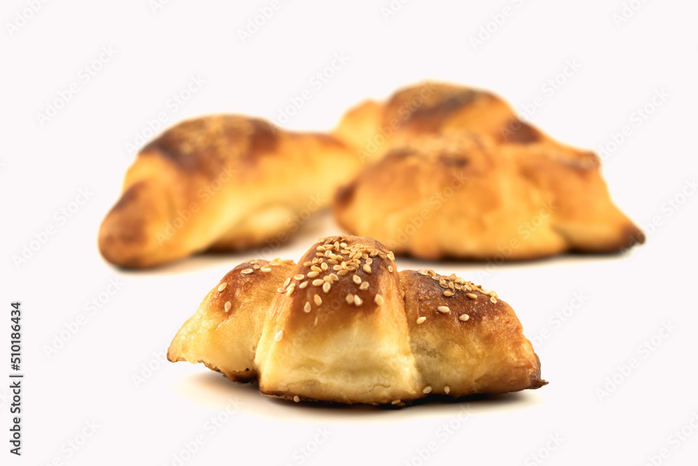 Homemade rolls with sesame stuffed with cheese isolated on a bright background. Selective focus. Close up.