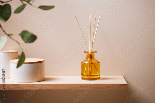 Reed diffusers and jars on shelf photo