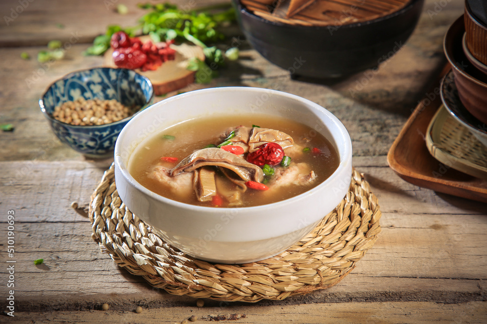 asian Chinese traditional herbal double boiled chicken pork meat hot soup with vegetables in bamboo bowl on retro kitchen dining background healthy menu