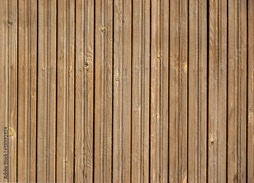 texture of a wooden brown fence with nails in a row