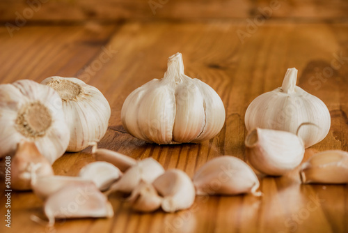 Garlic is a culinary and medicinal plant on a wooden background photo