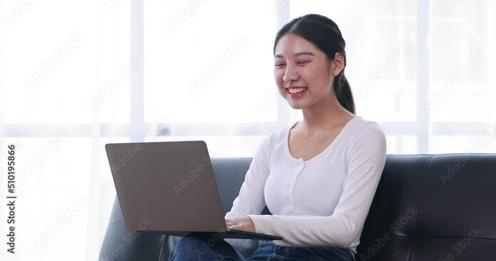 Young Asian lady studying online from home, reading a book and using laptop pc, sitting on the coffee shop, free space. E-learning, web-based education concept Young Asian lady studying online from home, reading a book and using laptop pc, sitting on the coffee shop, free space. E-learning, web-based education concept