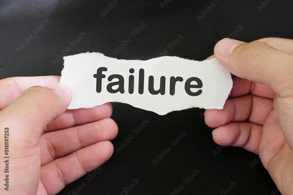 Handle and accept failure concept. Hand holding paper with written word failure in black background. Handle and accept failure concept. Hand holding paper with written word failure in black background.