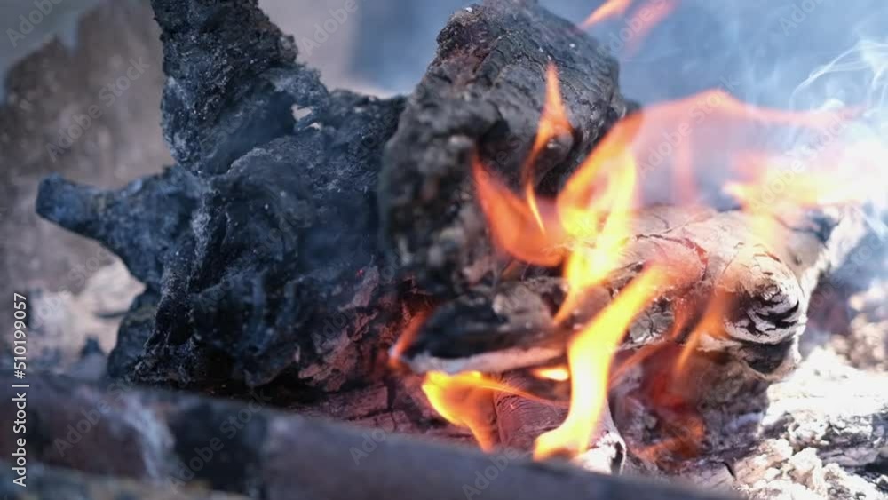 Firewood burning - slow motion video of Tongues of fire and smoke from coals in the grill Firewood burning - slow motion video of Tongues of fire and smoke from coals in the grill