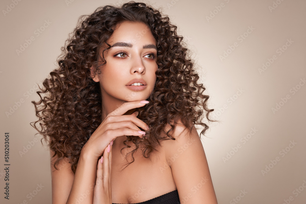 Fashion studio portrait of beautiful smiling woman with afro curls hairstyle. Fashion and beauty Fashion studio portrait of beautiful smiling woman with afro curls hairstyle. Fashion and beauty