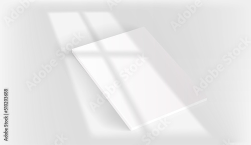 White book on a table with light of the window shadow overlay. Realistic vector mockup with sun flare effect