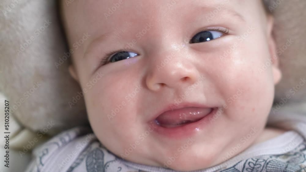 A two-month-old cute baby smiling cheerfully. Portrait of a playful and energetic child close-up A two-month-old cute baby smiling cheerfully. Portrait of a playful and energetic child close-up
