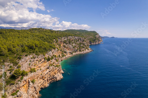 Aerial view of the Pasjaca cliff and beach, blue sea and mountains, Croatia