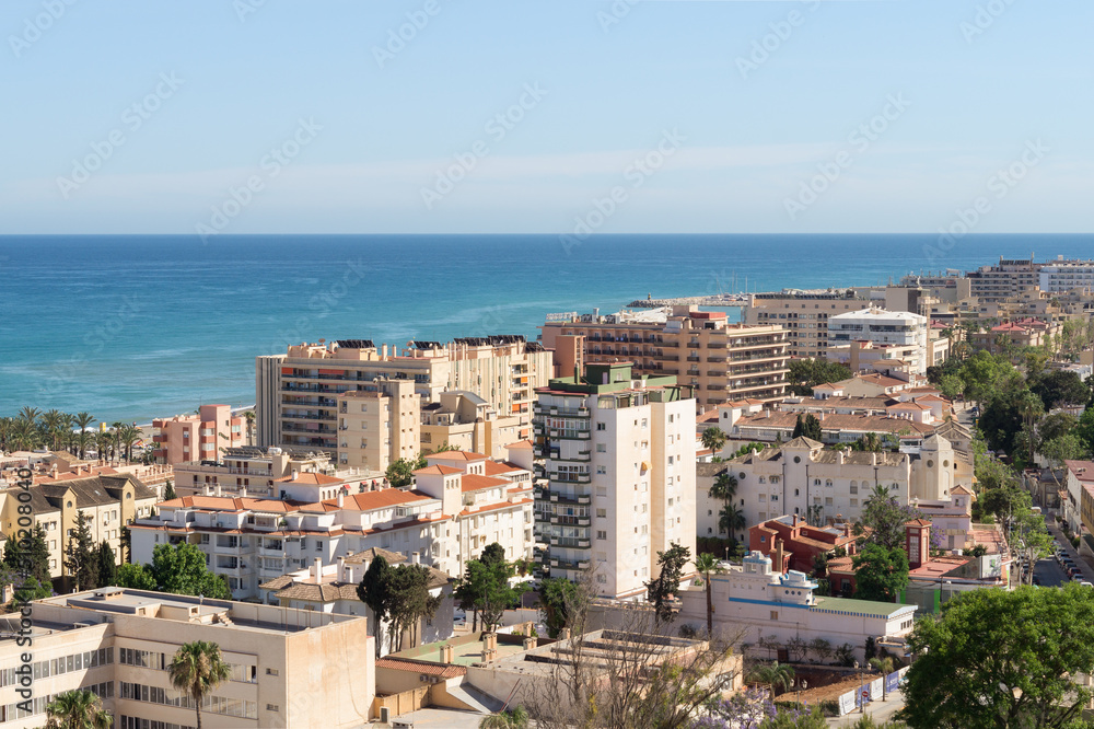 Views of La Carihuela neighbourhood in Torremolinos (Malaga, Spain) facing the Mediterranean Sea on a sunny day. Residential area with tourist flats on the Costa del Sol.