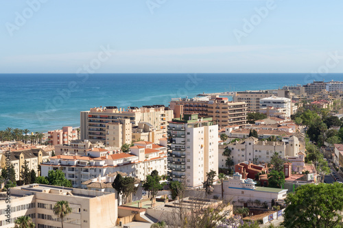 Views of La Carihuela neighbourhood in Torremolinos (Malaga, Spain) facing the Mediterranean Sea on a sunny day. Residential area with tourist flats on the Costa del Sol. photo