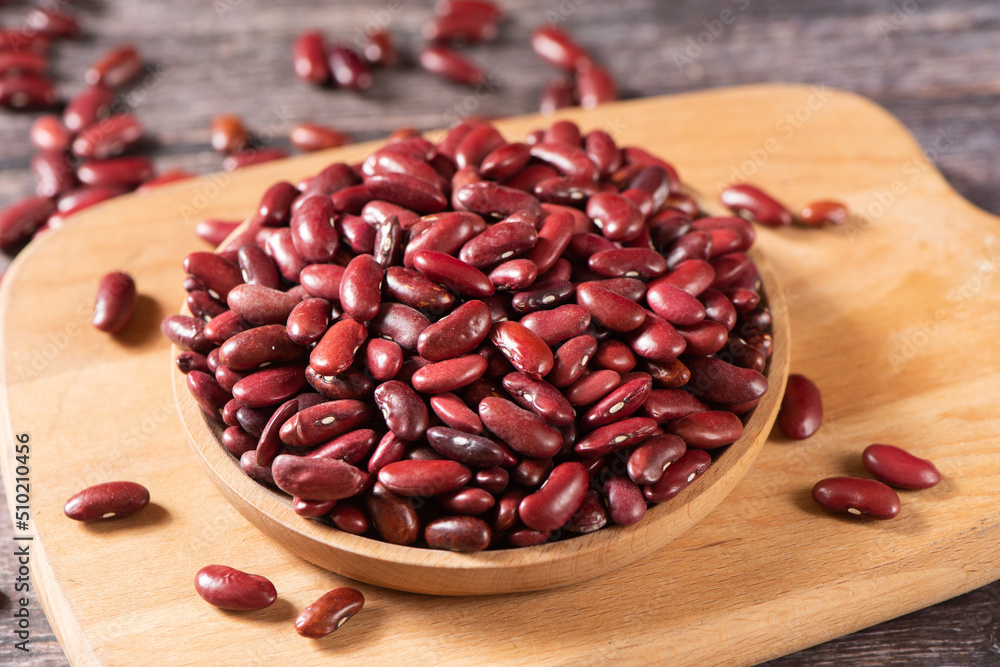 raw red kidney beans in plate on table. raw red kidney beans in plate on table.
