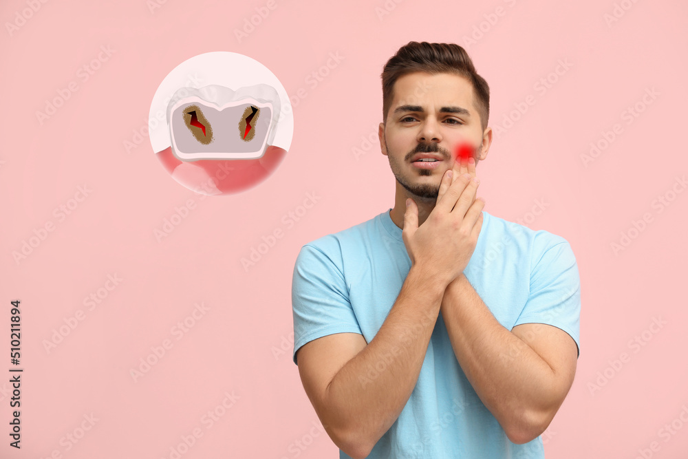 Young man suffering from toothache on pink background Young man suffering from toothache on pink background