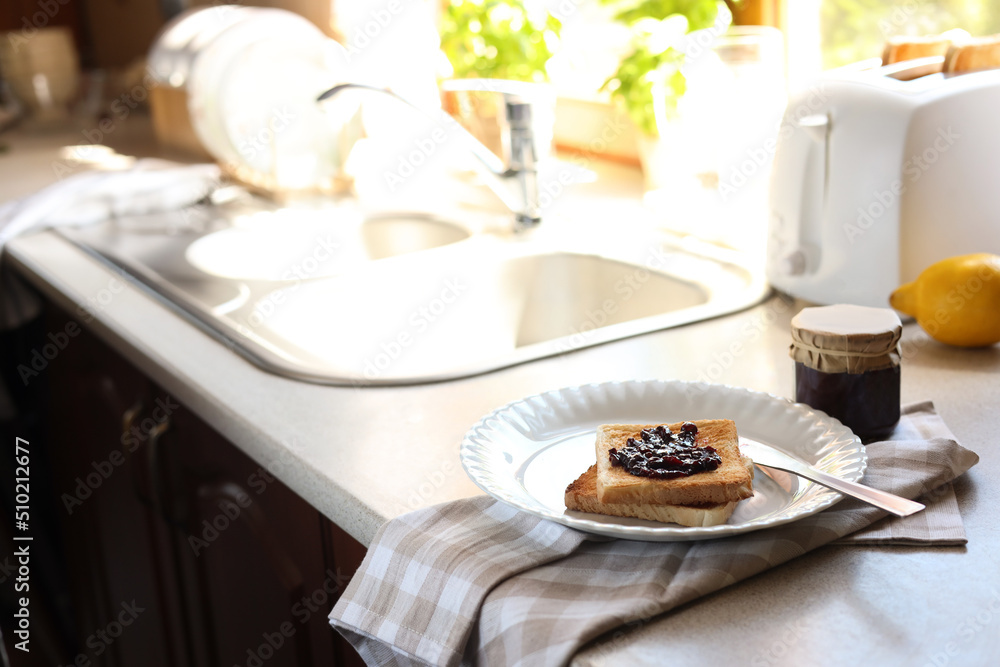 Tasty toasts with jam on countertop in kitchen, space for text Tasty toasts with jam on countertop in kitchen, space for text
