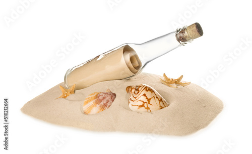 Corked glass bottle with rolled paper note and seashells on sand against white background
