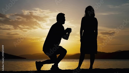Romantic silhouettes of a man who offers to marry a woman. Creating a new family she told him so in a beautiful landscape. photo