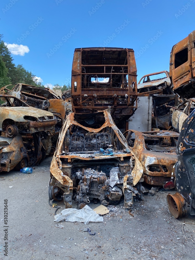 Car morgue. Civilian vehicles after the fire. Rusty pile of metal. Auto in Irpen. Car morgue. Civilian vehicles after the fire. Rusty pile of metal. Auto in Irpen.