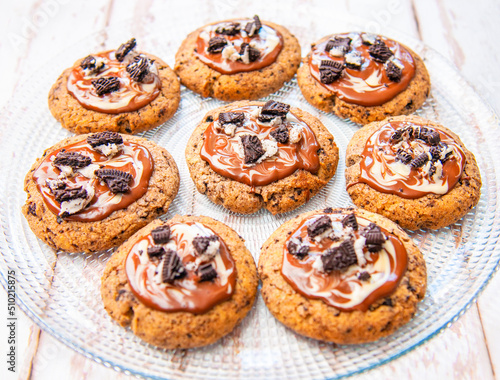 cookies with white and brown chocolate glaze on transparent, round plate