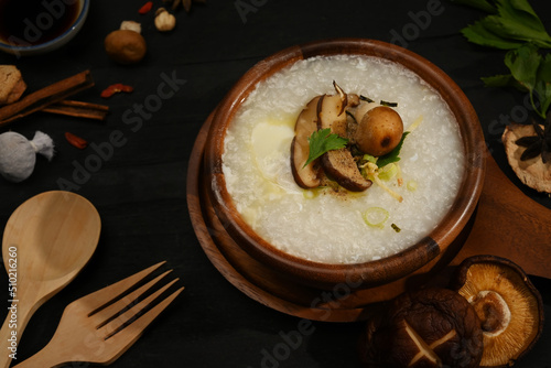 Rice porridge or congee with soft boiled egg, shiitake mushroom, slice ginger and slice scallion for healthy breakfast