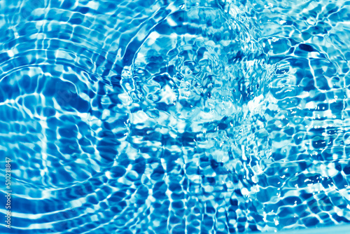 Abstract blue water background with circles. Ripples on water surface.