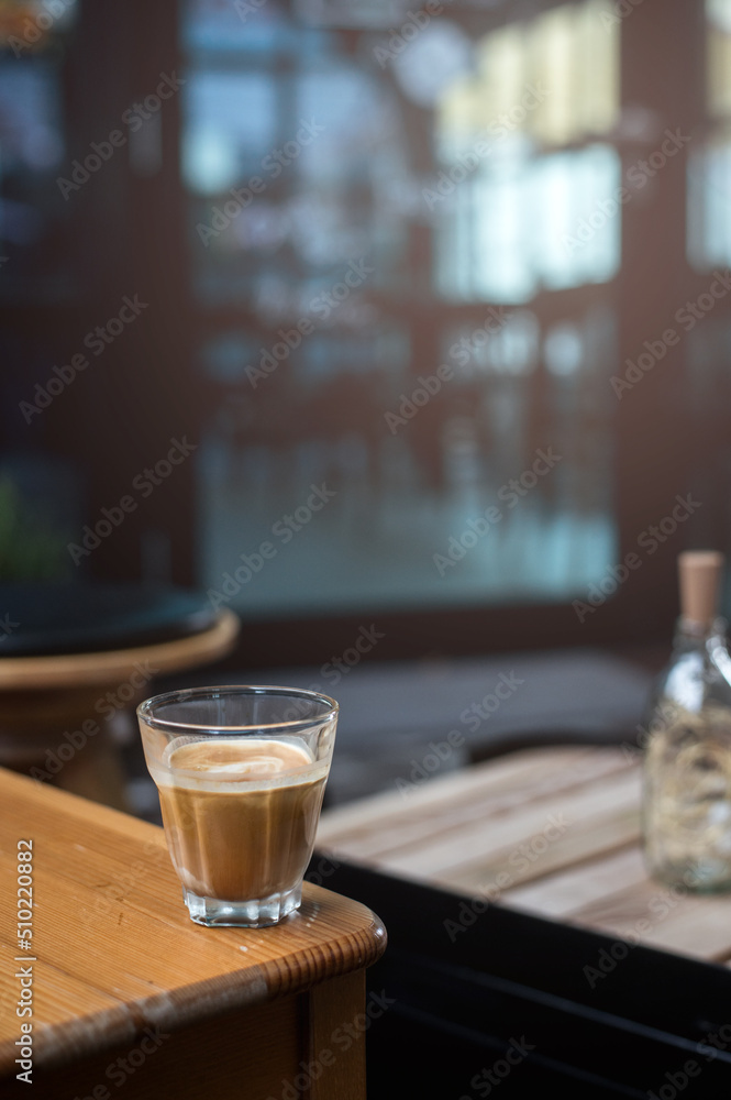 hot coffee on a table with cream being poured into it showing the texture hot coffee on a table with cream being poured into it showing the texture