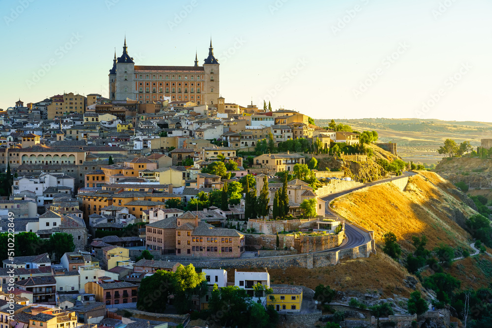 Skyline of the medieval city of Toledo at dawn with golden light.