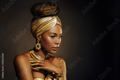 Fotografering Portrait Closeup Beauty fantasy african woman, face in gold paint