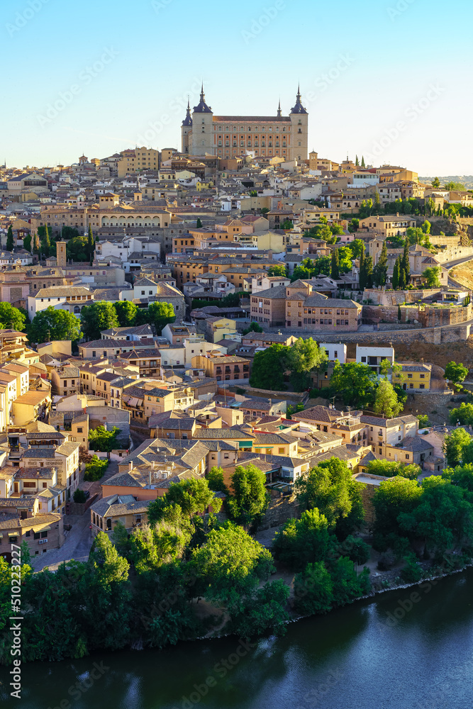 Houses of the city of Toledo with the impressive Alcazar on top of hill and downstream.